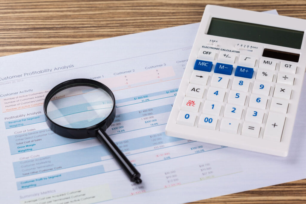 calculator and magnifying glass on the table utc